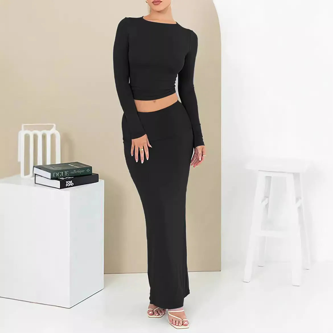 Women's black sweet style two-piece suit with three-quarter sleeve top and long skirt.