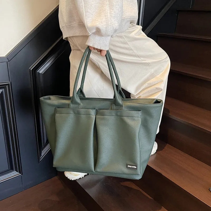 Lightweight PU shoulder bag in solid colour with ventilation features and 20-35L capacity