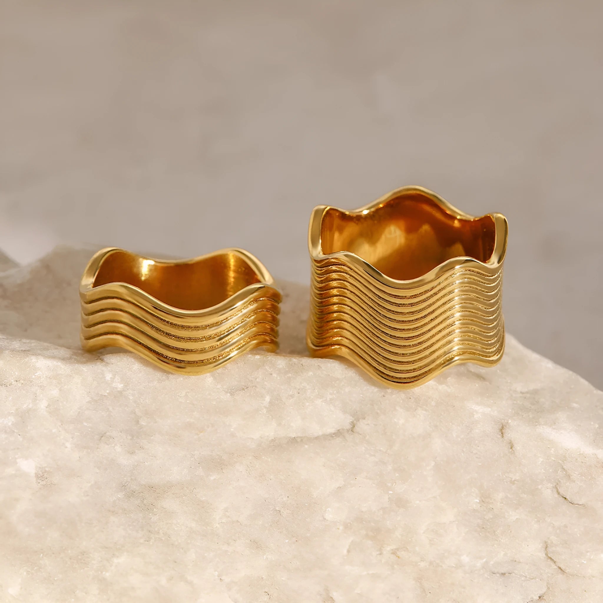 Stainless steel geometric wide band ring with a wave pattern design, shown in an electroplated colour finish.