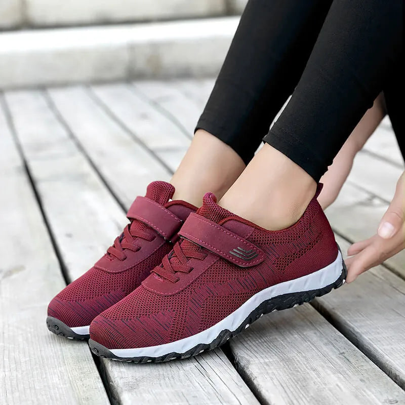 Women's low-top casual sneaker with mesh upper, wedge heel, and Velcro strap fastening.