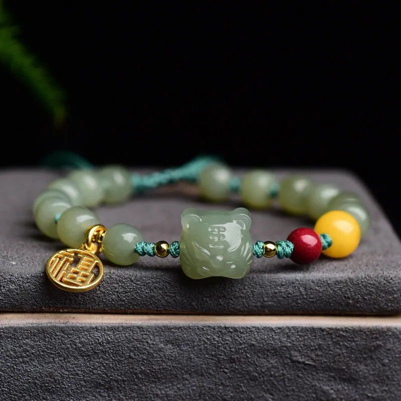 Natural Hetian Jade bracelet with cinnabar and beeswax beads in animal zodiac design.