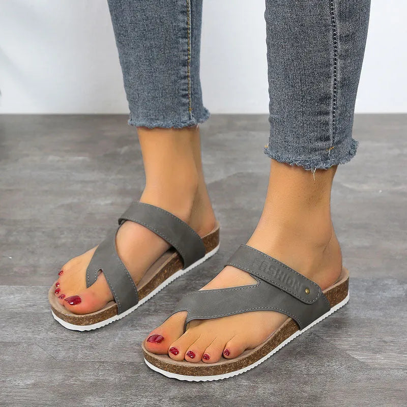 Flat toe ring thick-soled flip-flops in blue, showing artificial PU upper and foam sole.