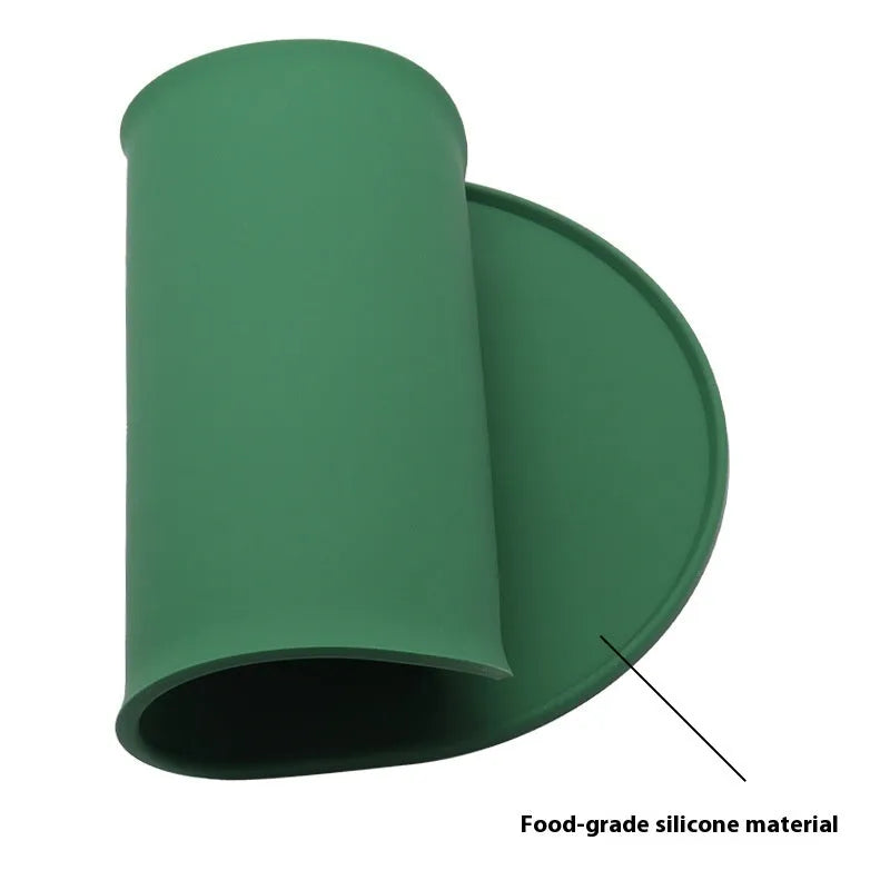 Green silicone waterproof cat feeding placemat with food bowl on it, showing non-slip textured surface.