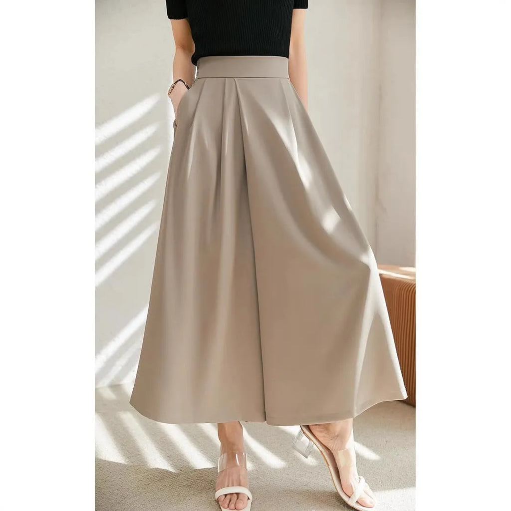 Wide-leg women's trousers in milk apricot with stacked hem design and pockets, flat lay view