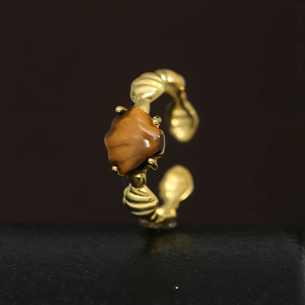 Silver adjustable ring with a white shell and tiger eye stone design in electroplated finish