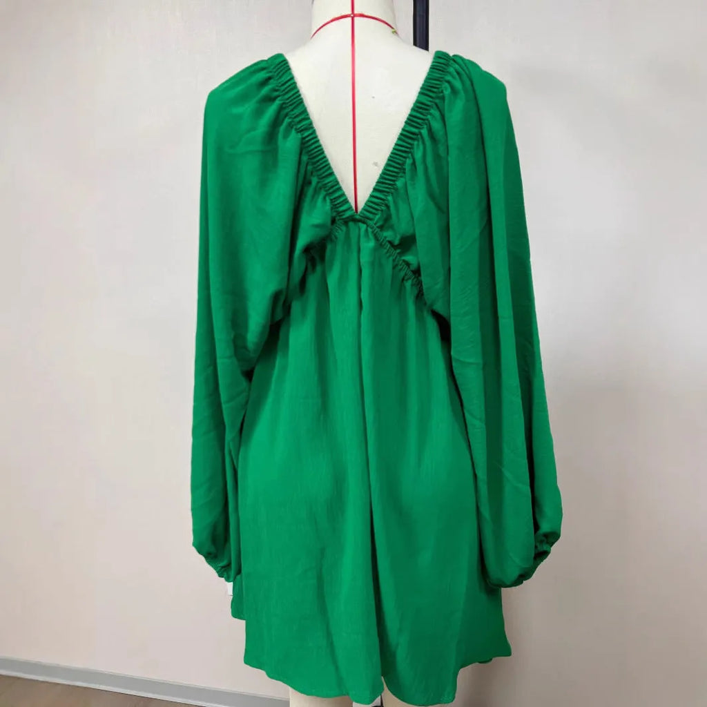Women's apricot V-neck dress with long puff sleeves and a flounced swing skirt, mid-waist fit.