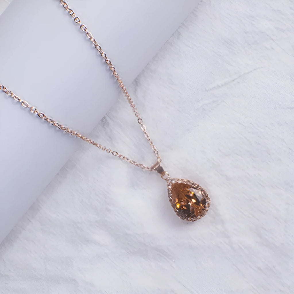Geometric drop shape alloy necklace with rhinestone accents in rose gold pink finish