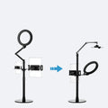 Black aluminium floor stand with fill light holding a mobile phone for video shooting.