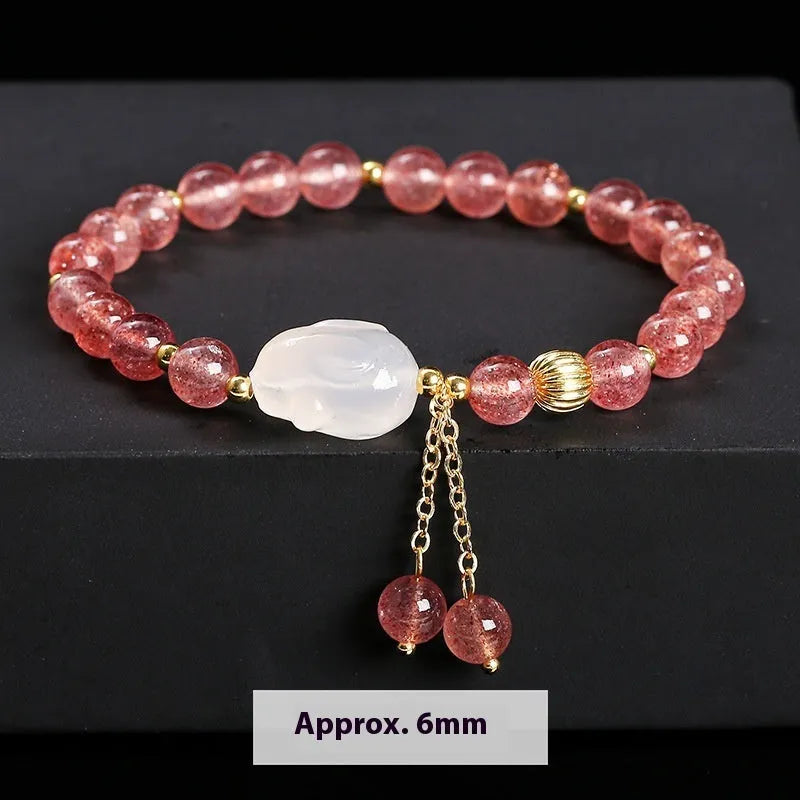 Women's white rabbit bracelet with 6mm round strawberry quartz agate beads in a geometric pattern.
