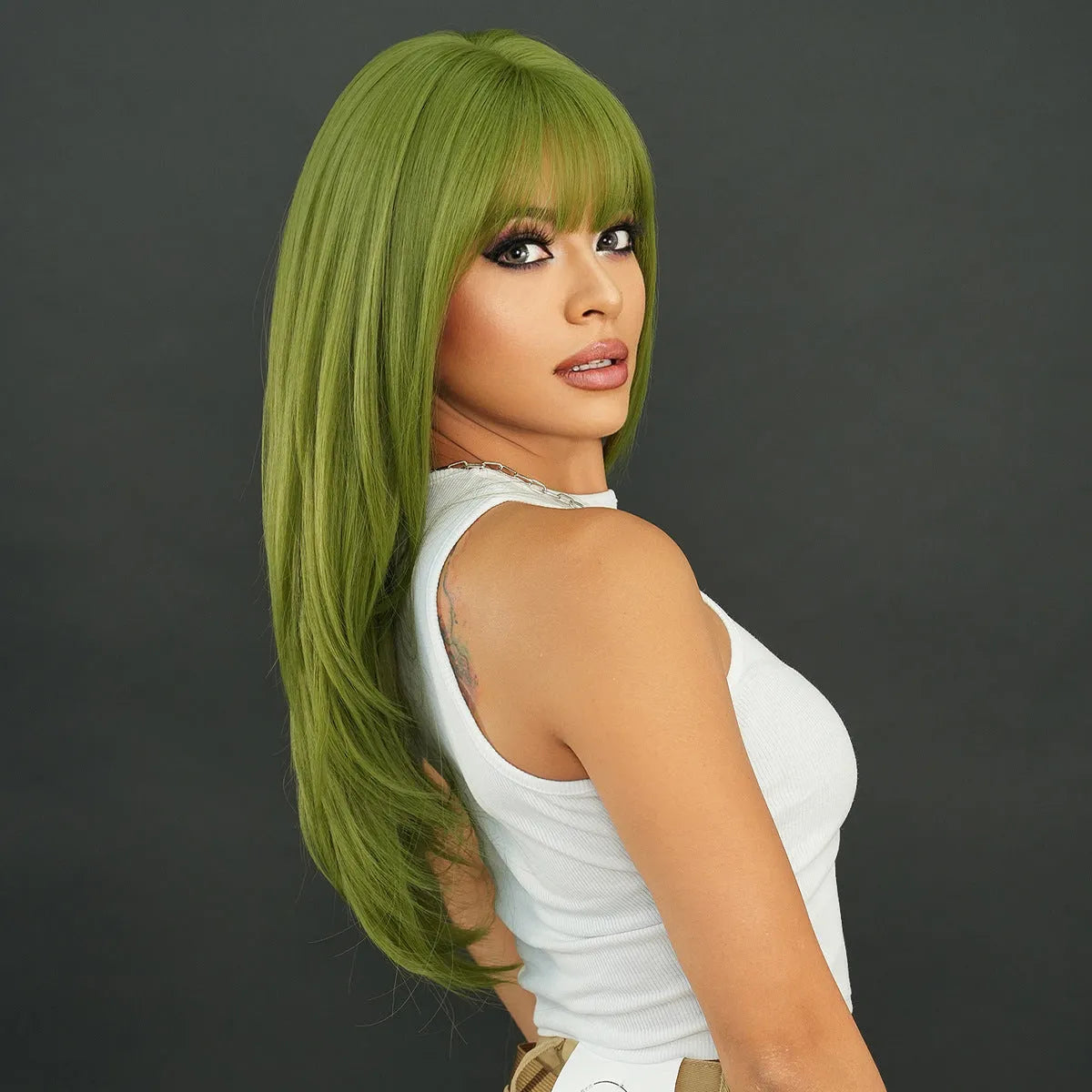A woman wearing a long, straight vanilla green wig with a full fringe, measuring 63cm in length.