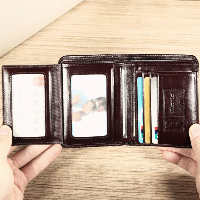 Men's brown leather bifold wallet open to show photo slot, card slots, billfold, and coin pocket.