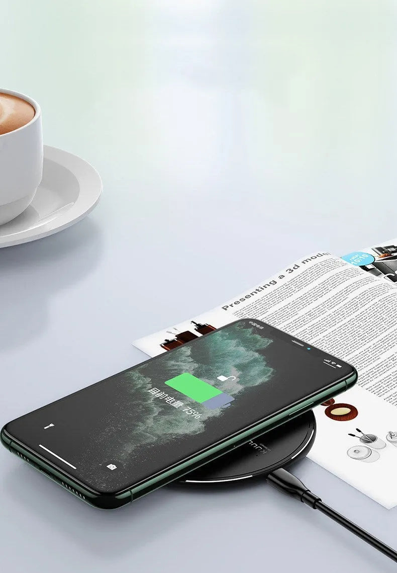 Black Kuulaa KL-CD16 wireless charging disc for mobile phones on a surface