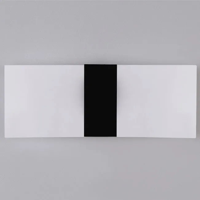 Modern acrylic LED wall lamp in silver finish showing warm light illumination