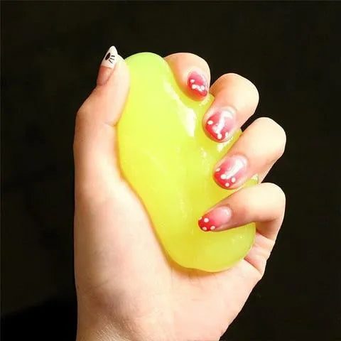 Blue and yellow magic cleaning gel putty for dust removal on a keyboard
