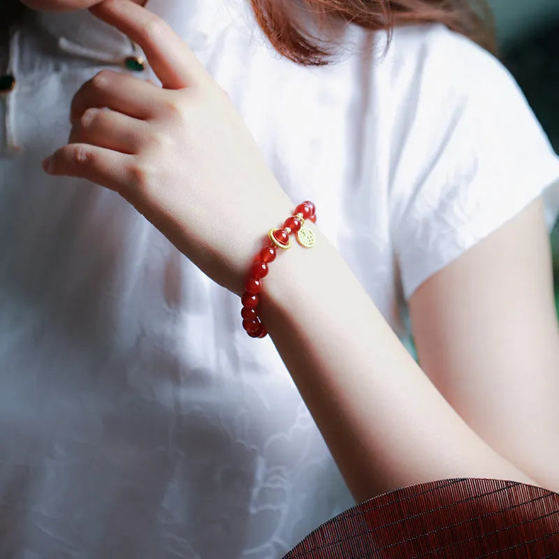 Handwoven natural red agate beaded bracelet with cultural style, shown with a blessing card.