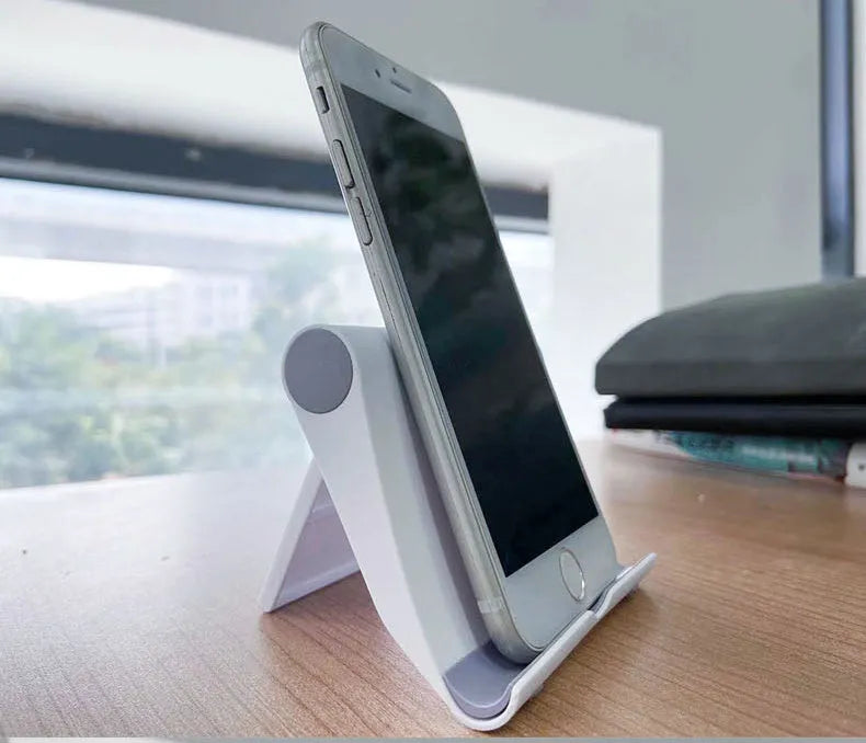Folding mobile phone tablet stand in multiple colours showing adjustable angle mechanism