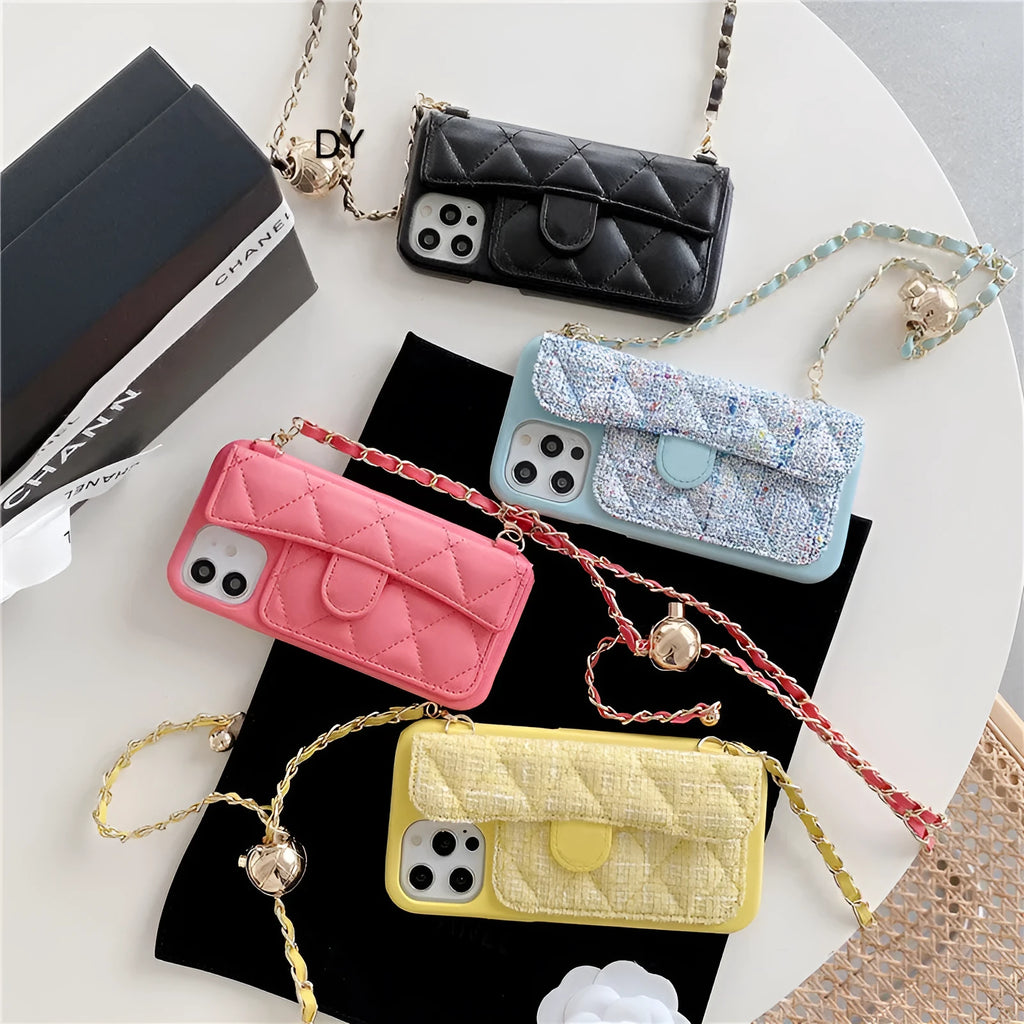 Imitation leather iPhone compatible phone case with long chain and golden ball detail in black, pink, yellow, or blue