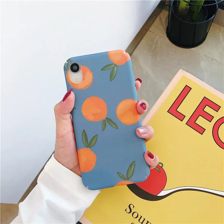 Orange and blue retro design plastic back cover case for iPhone on a table.
