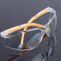 Transparent polycarbonate safety goggles with yellow lenses for eye protection.