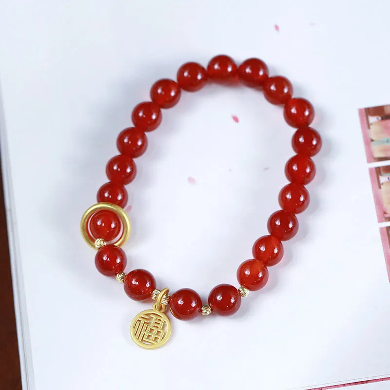 Handwoven natural red agate beaded bracelet with cultural style, shown with a blessing card.