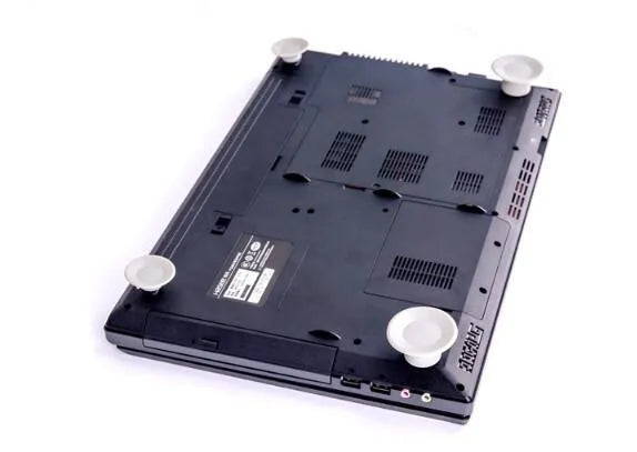 Grey durable plastic laptop cooling pads, two large and two small, on a desk.