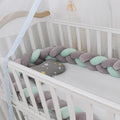 A bendable baby crib bumper in spandex crystal velvet, shown in a bright colour, shaped around a cot.