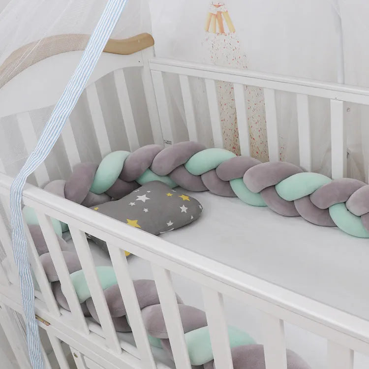 A bendable baby crib bumper in spandex crystal velvet, shown in a bright colour, shaped around a cot.