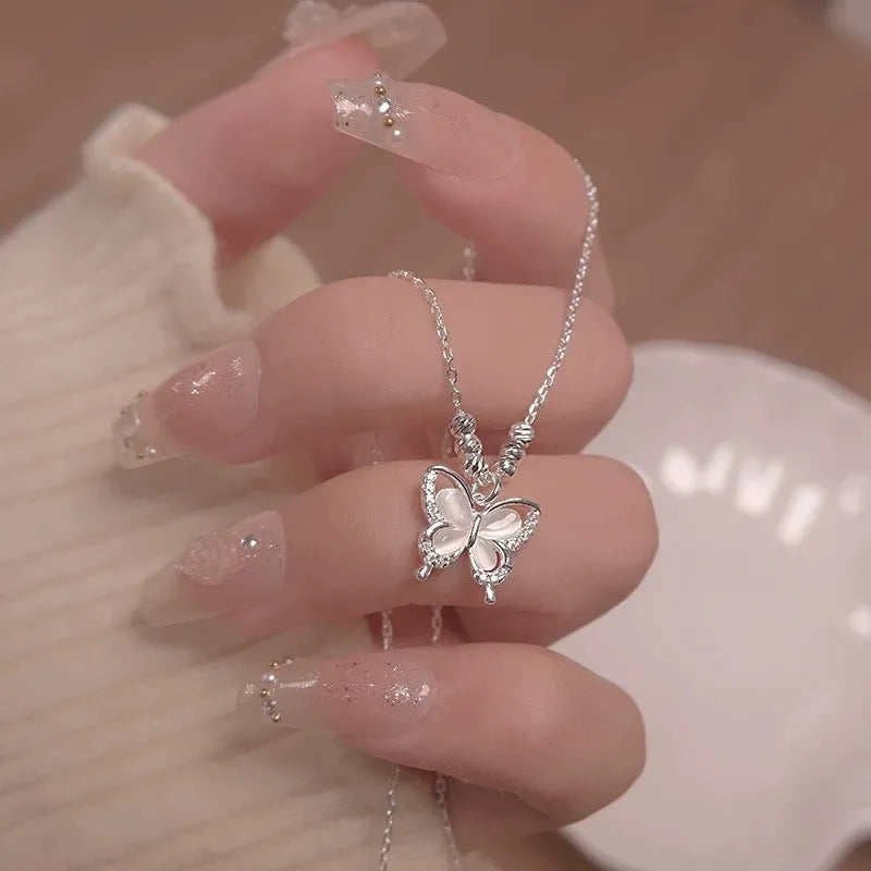 Women's silver butterfly necklace with a cross chain, showing the 925 silver pendant and adjustable length.