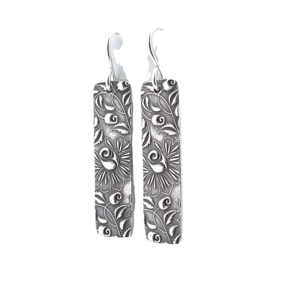 Silver geometric long earrings with a carved vine pattern in a retro style