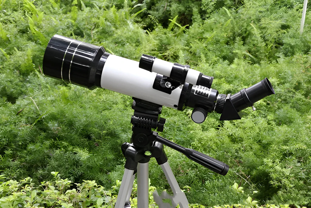 Dark blue children's astronomical monocular telescope on a tripod for stargazing.