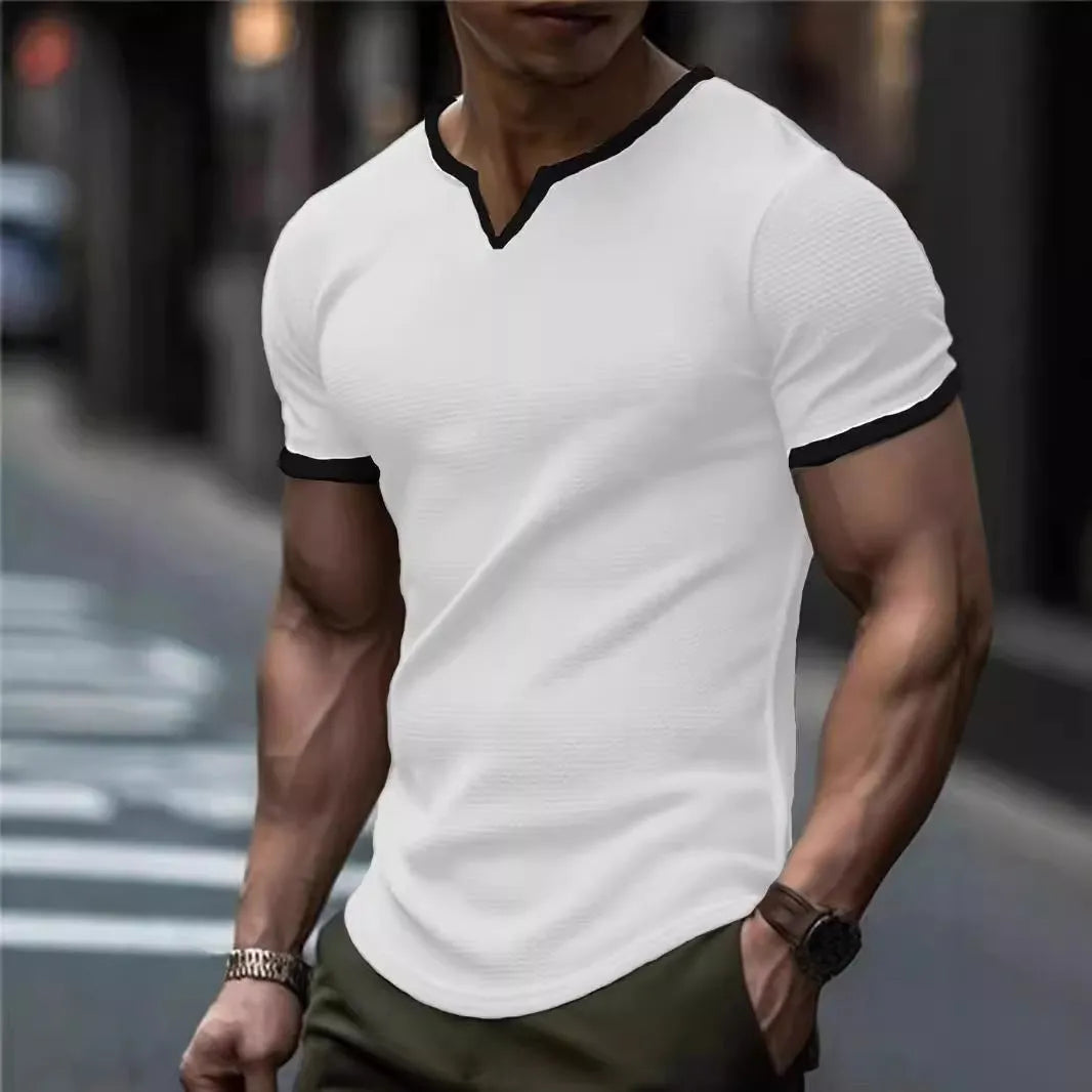 Man wearing a grey and white colour-block V-neck waffle knit short sleeve T-shirt.