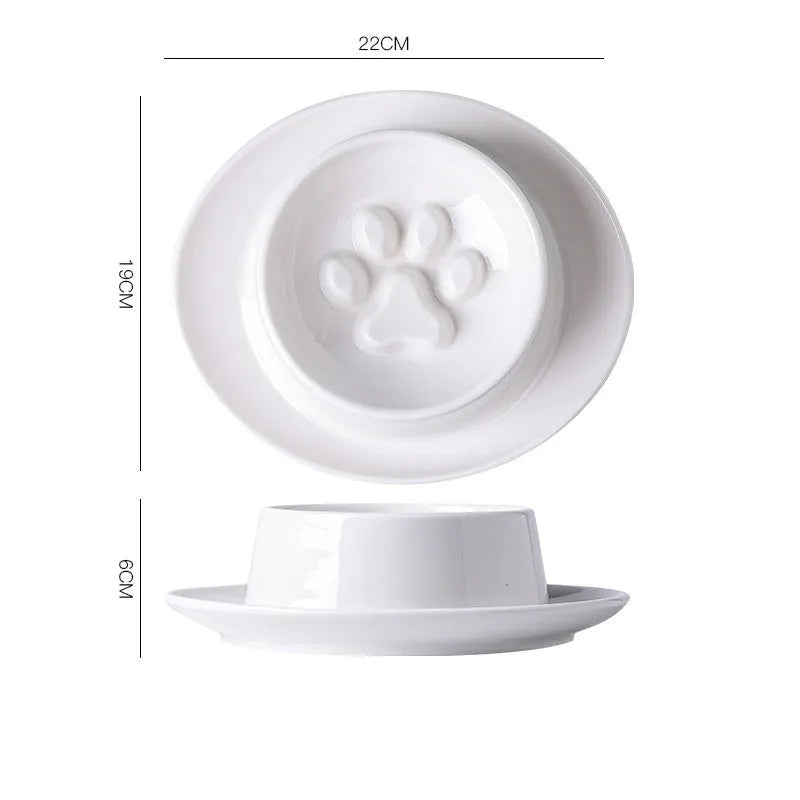 Green ceramic slow feeder pet bowl with internal maze pattern and raised basin design on a wooden floor.