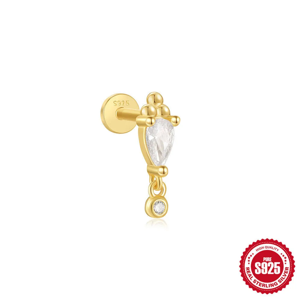 Close-up of a sterling silver ear stud with a gold-toned tassel inlay design.