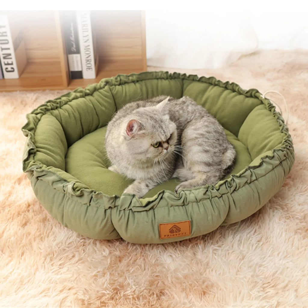Grey donut-shaped cat bed with raised sides and reversible design