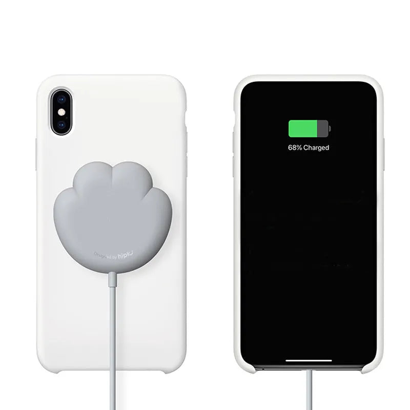 Pink cat claw sucker wireless charger on a desk with USB cable attached