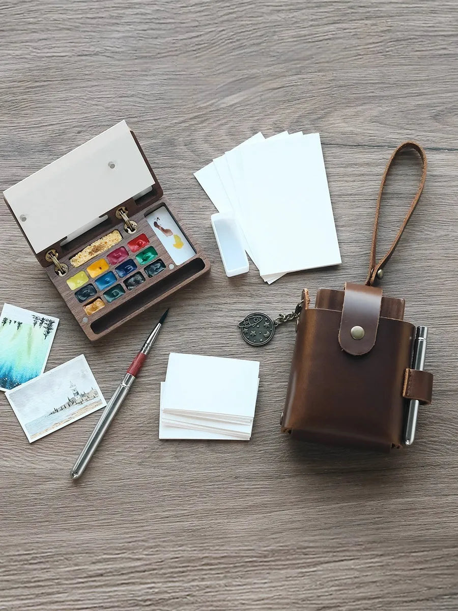 Mini walnut wood watercolour paint box set open showing internal brush and paint compartments.