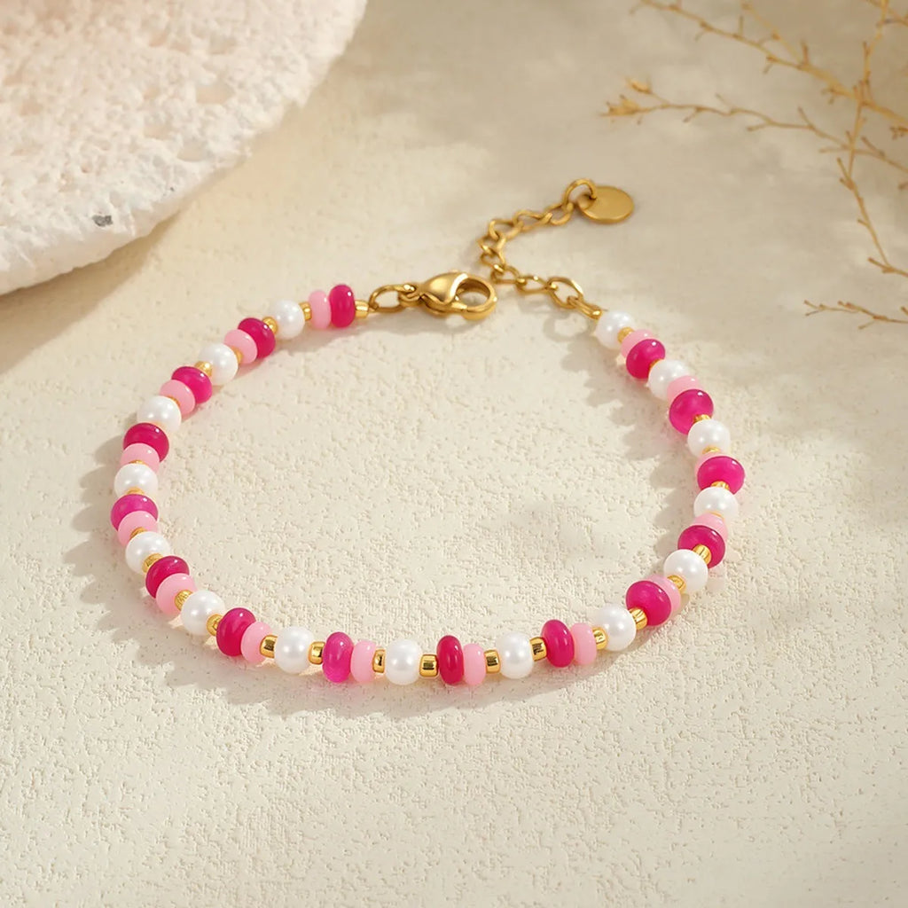 Sweet resin beaded necklace with geometric 18K stainless steel pendant, pink beads, and regular chain on light background