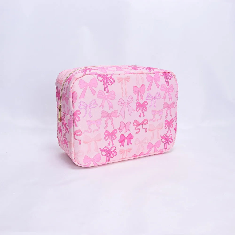 Printed nylon cosmetic bag in pink bow, pink stripes, blue or white with polyester lining and four sizes