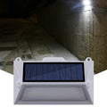 Solar-powered outdoor step light with motion sensor in abstract design for mounting on walls or steps.