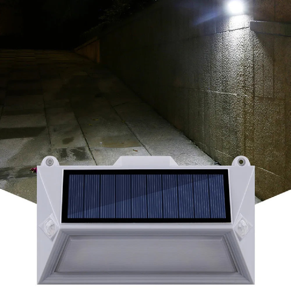 Solar-powered outdoor step light with motion sensor in abstract design for mounting on walls or steps.