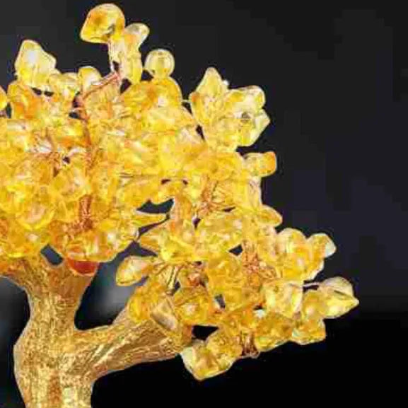 Citrine-coloured resin Feng Shui ornament of a small turtle on a money tree.