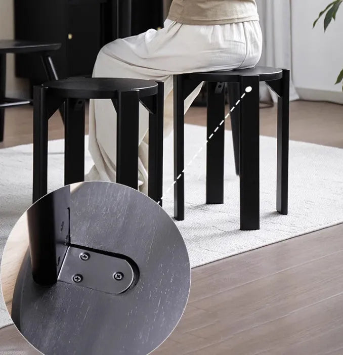 A stackable round metal dining stool in a modern style, shown in a choice of colours.