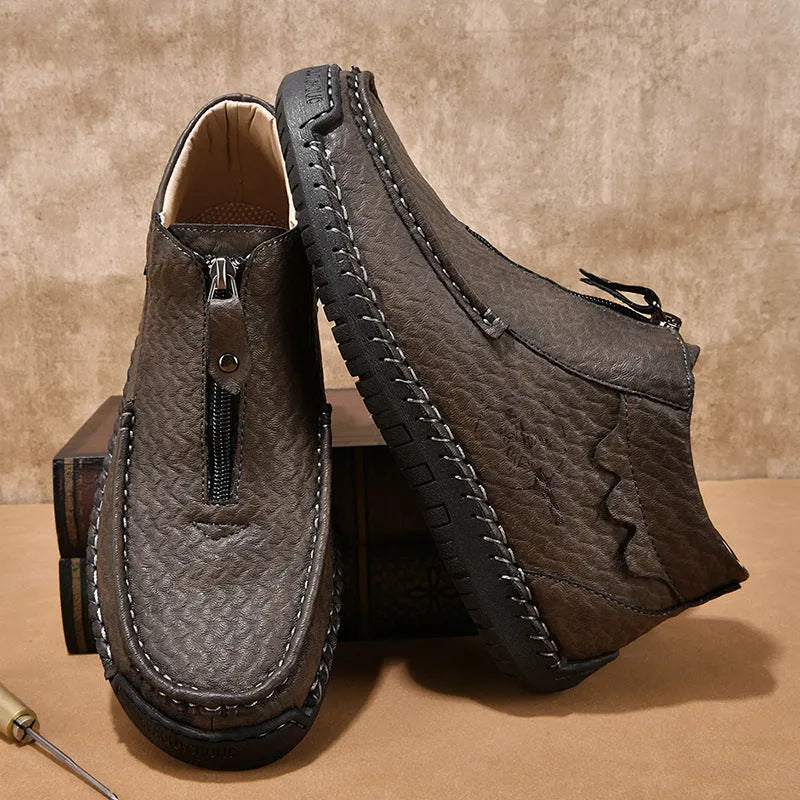 Men's black slip-on leather loafers with round toe and sewn sole detail on a white background.