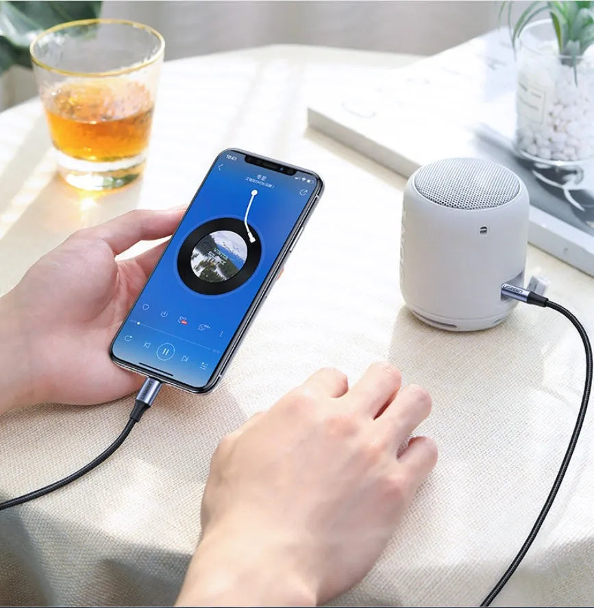 Black Apple Lightning to 3.5mm audio adapter cable with braided fabric and aluminum connector shell.