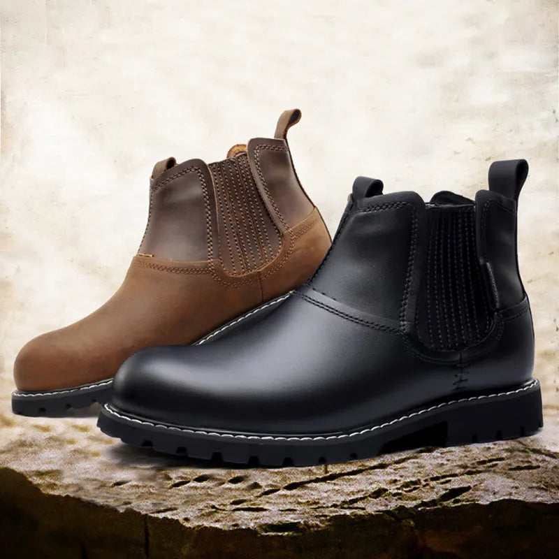 Men's round toe ankle boots in black with lace-up closure and rubber sole on outdoor ground