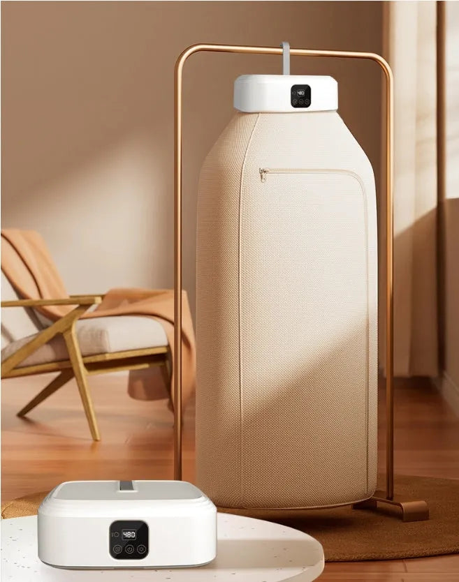 White cylindrical laundry dryer with remote control on countertop showing compact 29cm height