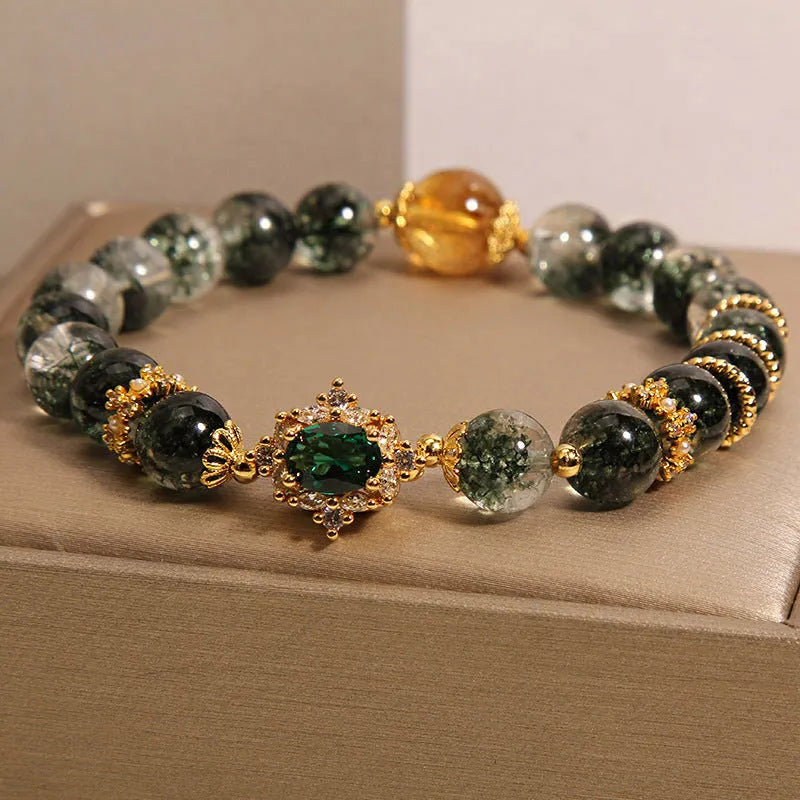 Women's crystal bracelet with gold rutilated quartz, green phantom quartz, and ruby quartz gemstones
