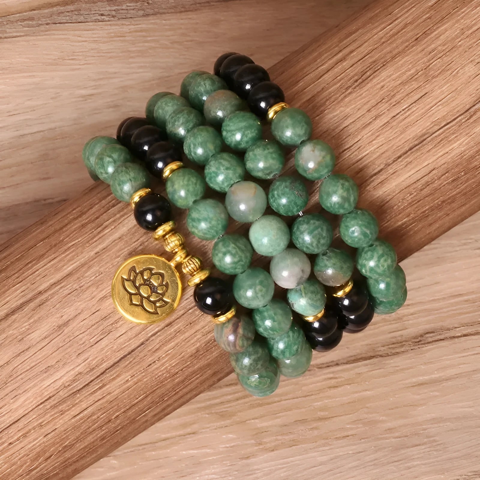 Green and black alloy bead elastic bracelet on a black stretch cord.