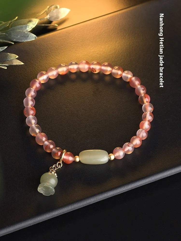 Ice Float Nanhong Agate bracelet with flower shape and bamboo joint details in ethnic style.
