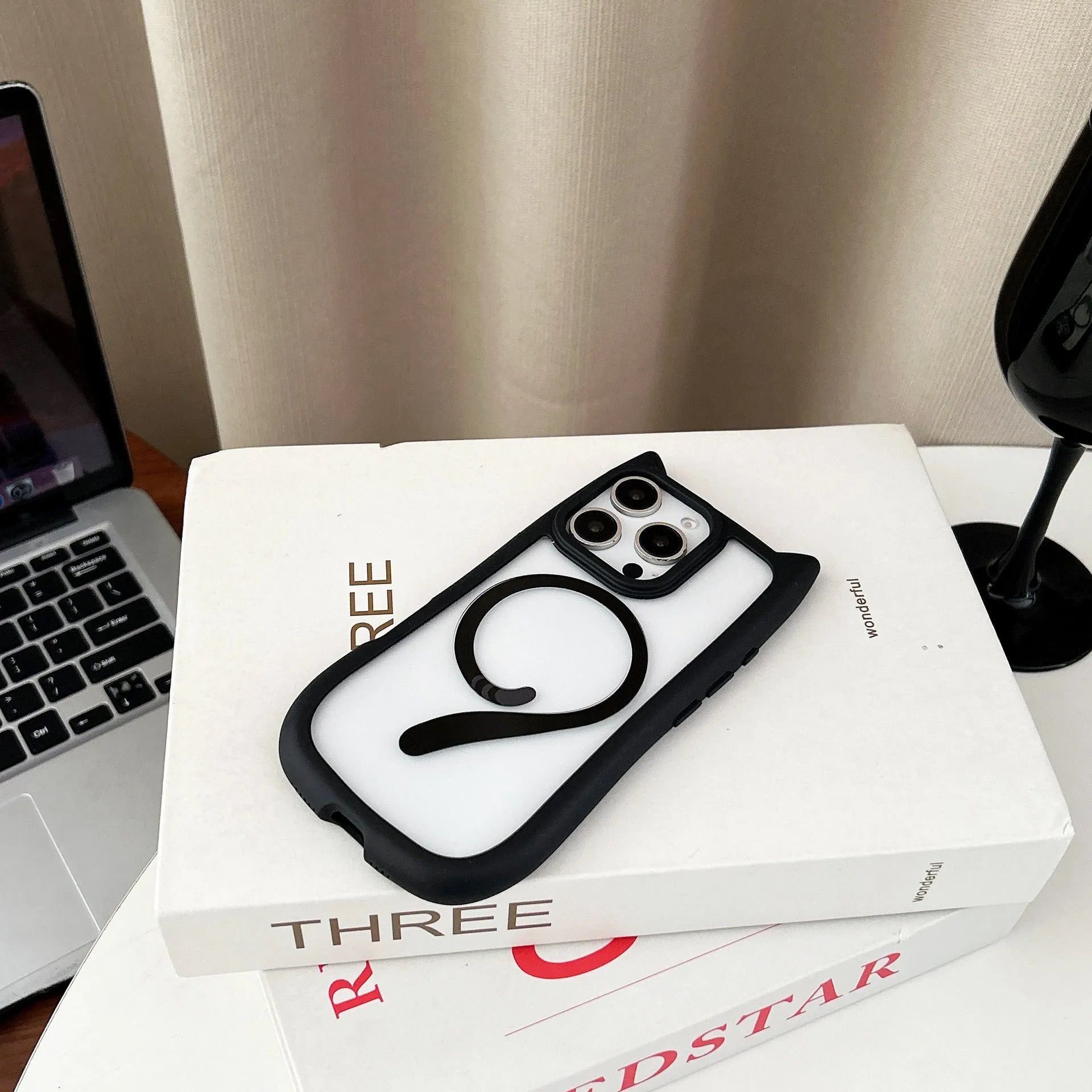 Transparent two-in-one acrylic and TPU phone case for iPhone 17 models on a table.